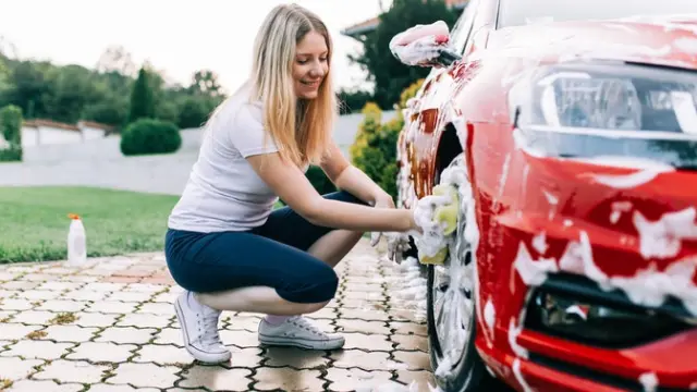 Woman washing red car