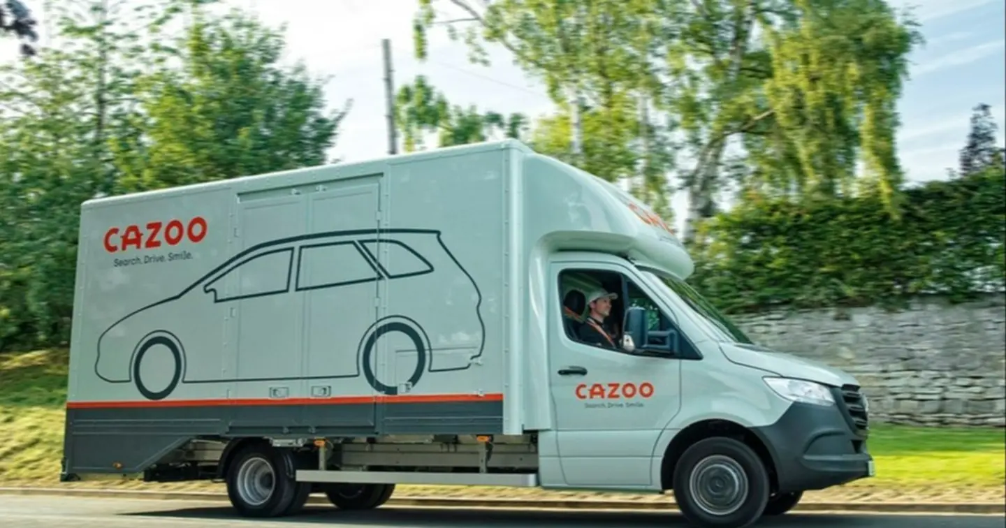 A Cazoo transporter delivering a car